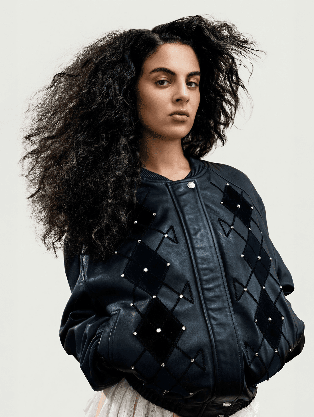 Custom Lou Menais wordmark applied on a contemporary couture garment, showcasing the visual identity developed for the fashion house.